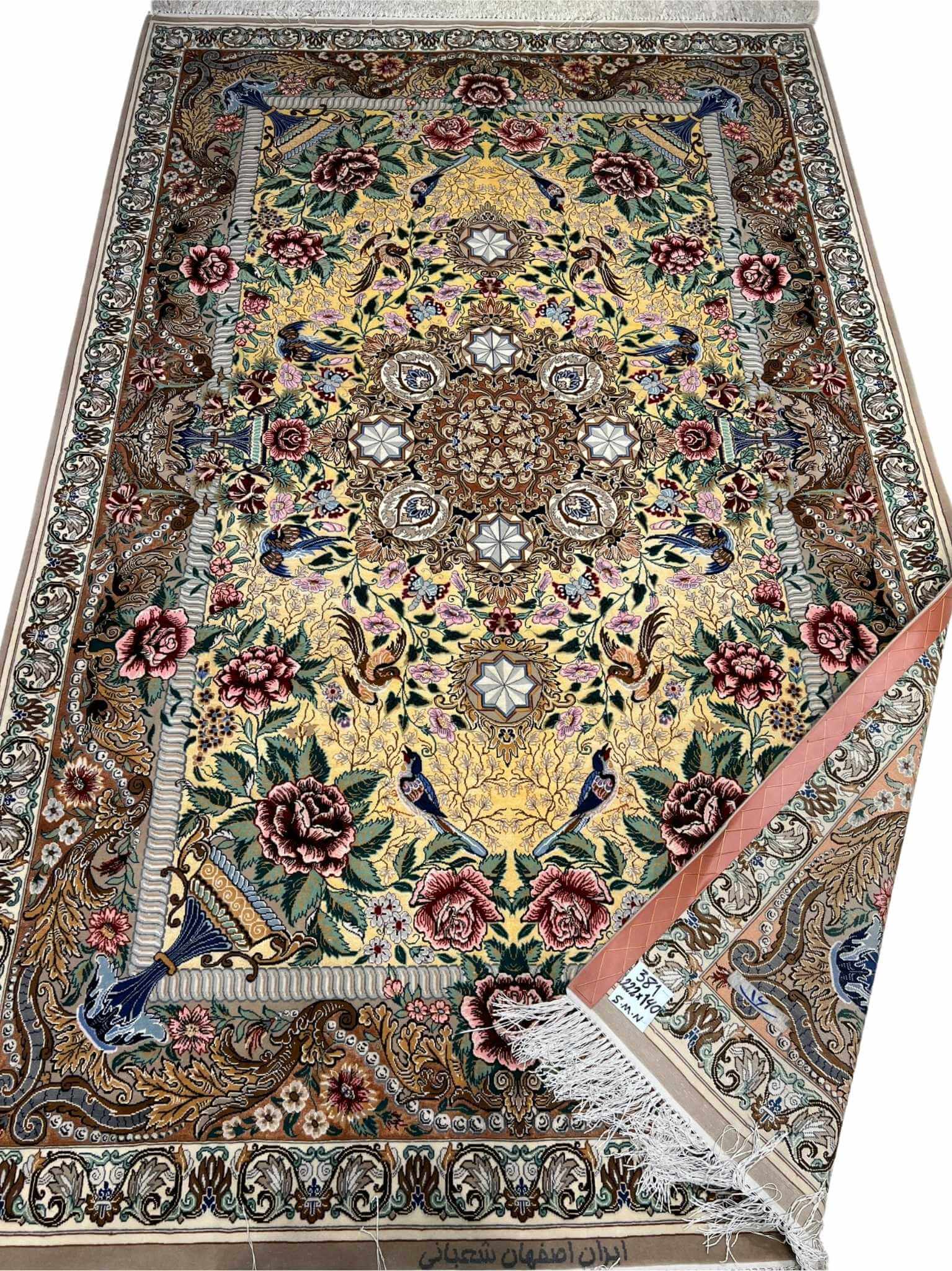 Hand-knotted wool and silk Persian carpet with intricate details.